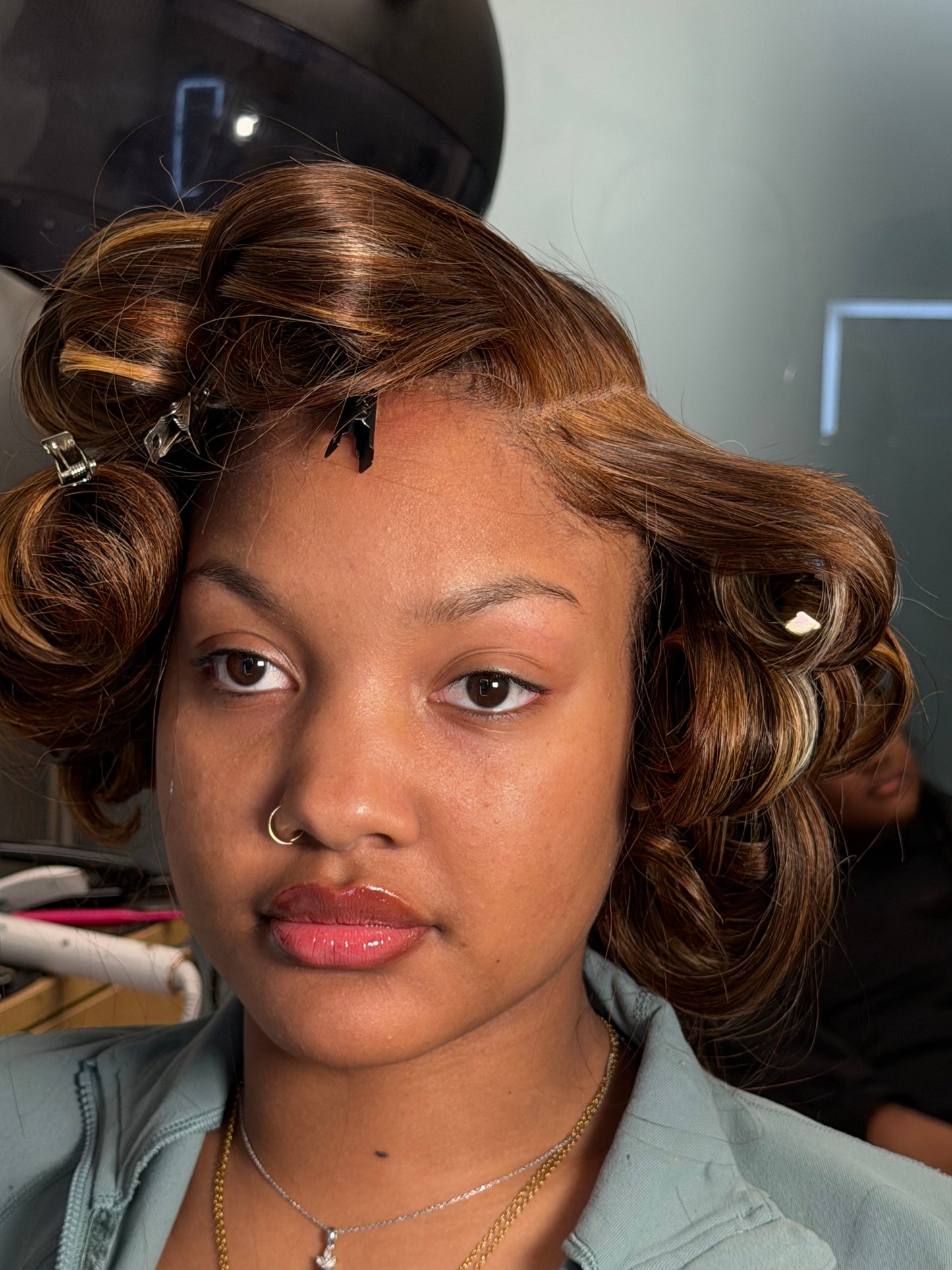 Model wearing Flawless-HD Closures styled in vintage curls with hair rollers.